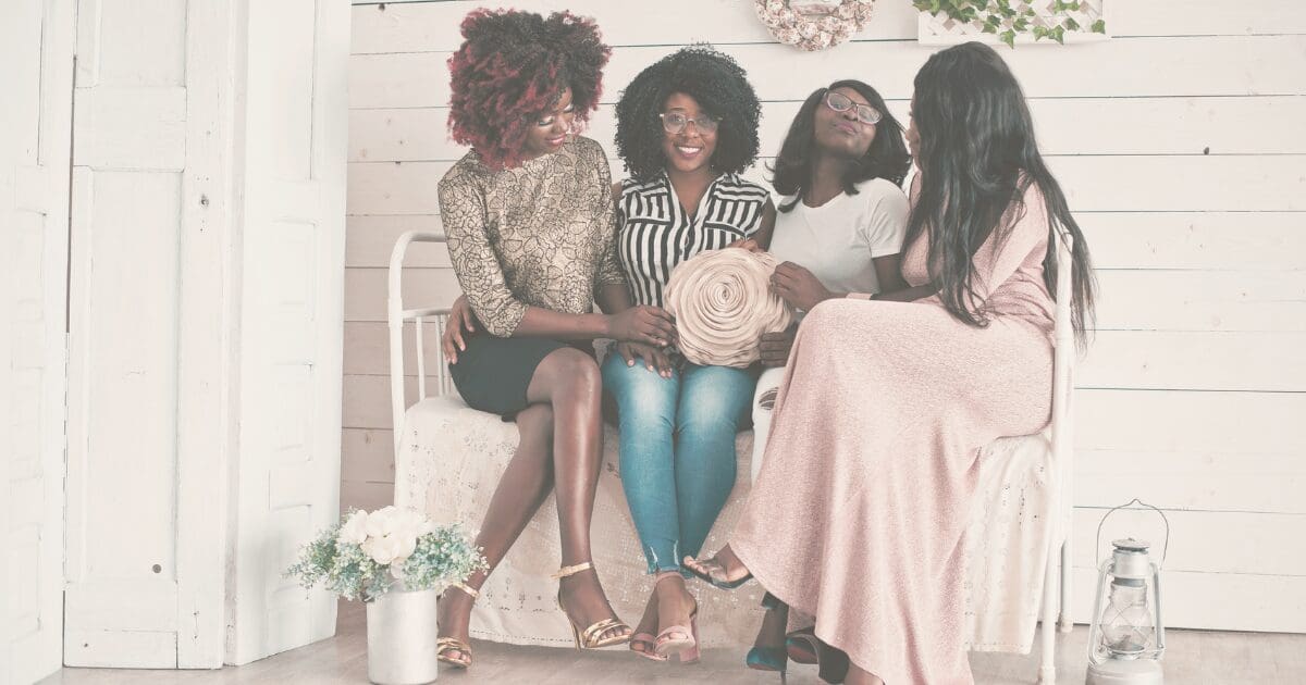 A group of women embracing in support of one another, for the Prayer & Perspective devotional "Your Pressure Does Not Define You"