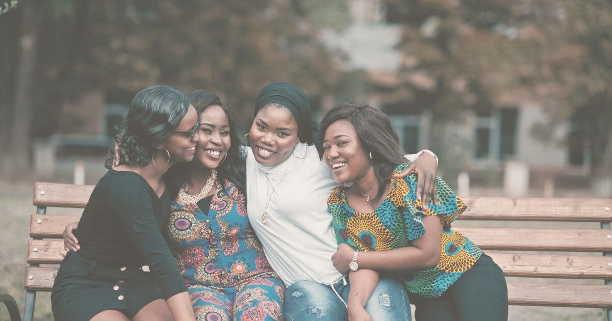 A group of women gathered close together, choosing peace and connection over worry, for the Prayer & Perspective devotional "Peace Begins with a Choice"