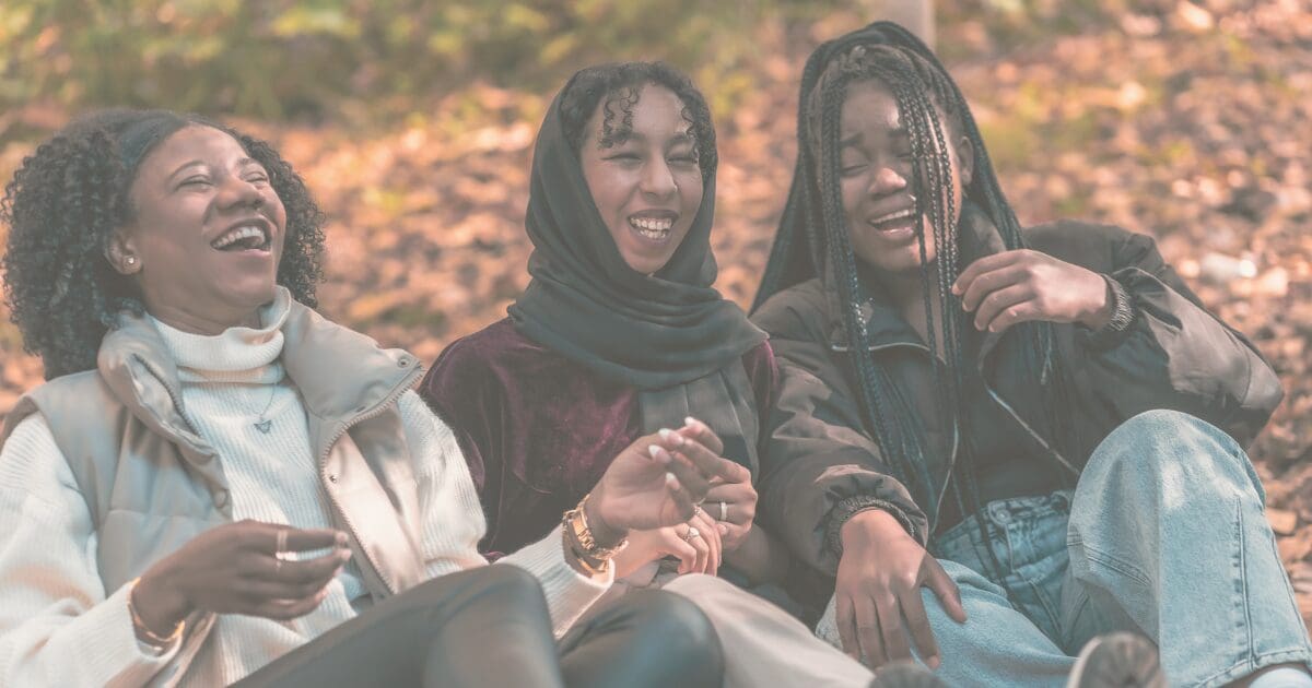 Two women sharing a warm embrace outdoors, a quiet, steady moment of peace, for the Prayer & Perspective devotional "Peace Grows Through Daily Practice"