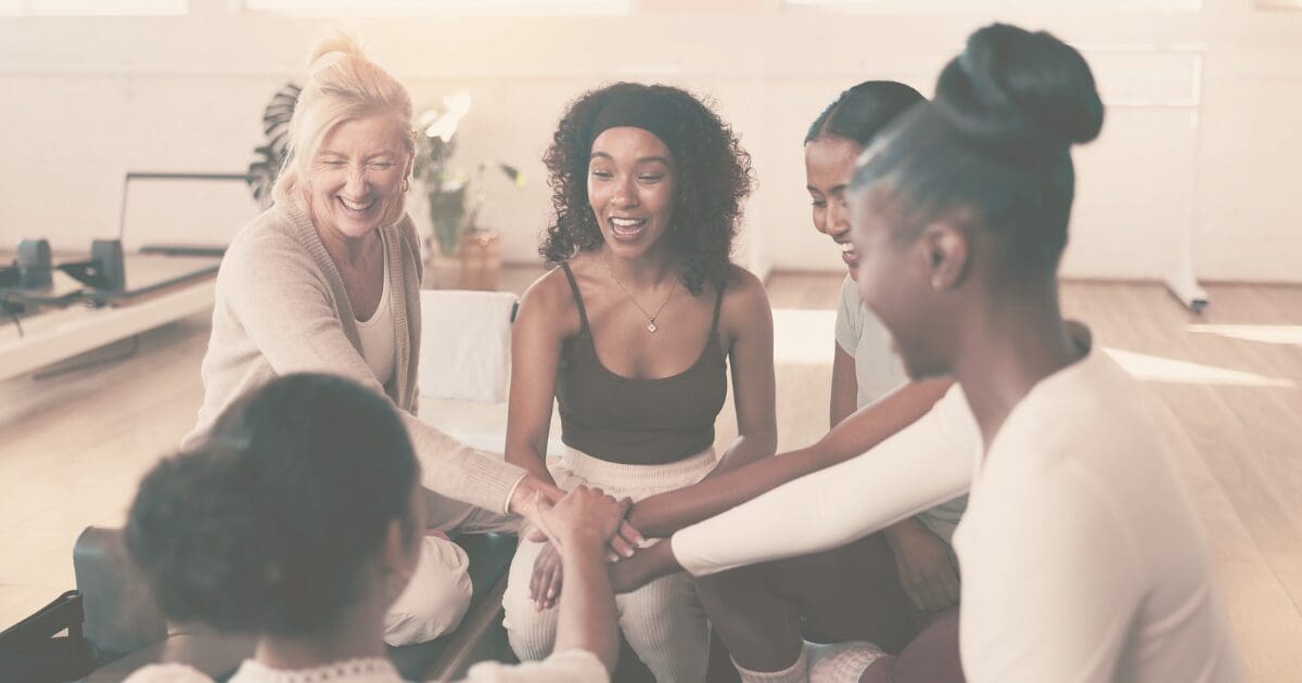 A group of women sitting together outdoors, at ease in each other's company, for the Prayer & Perspective devotional "Peace Grows with Practice"