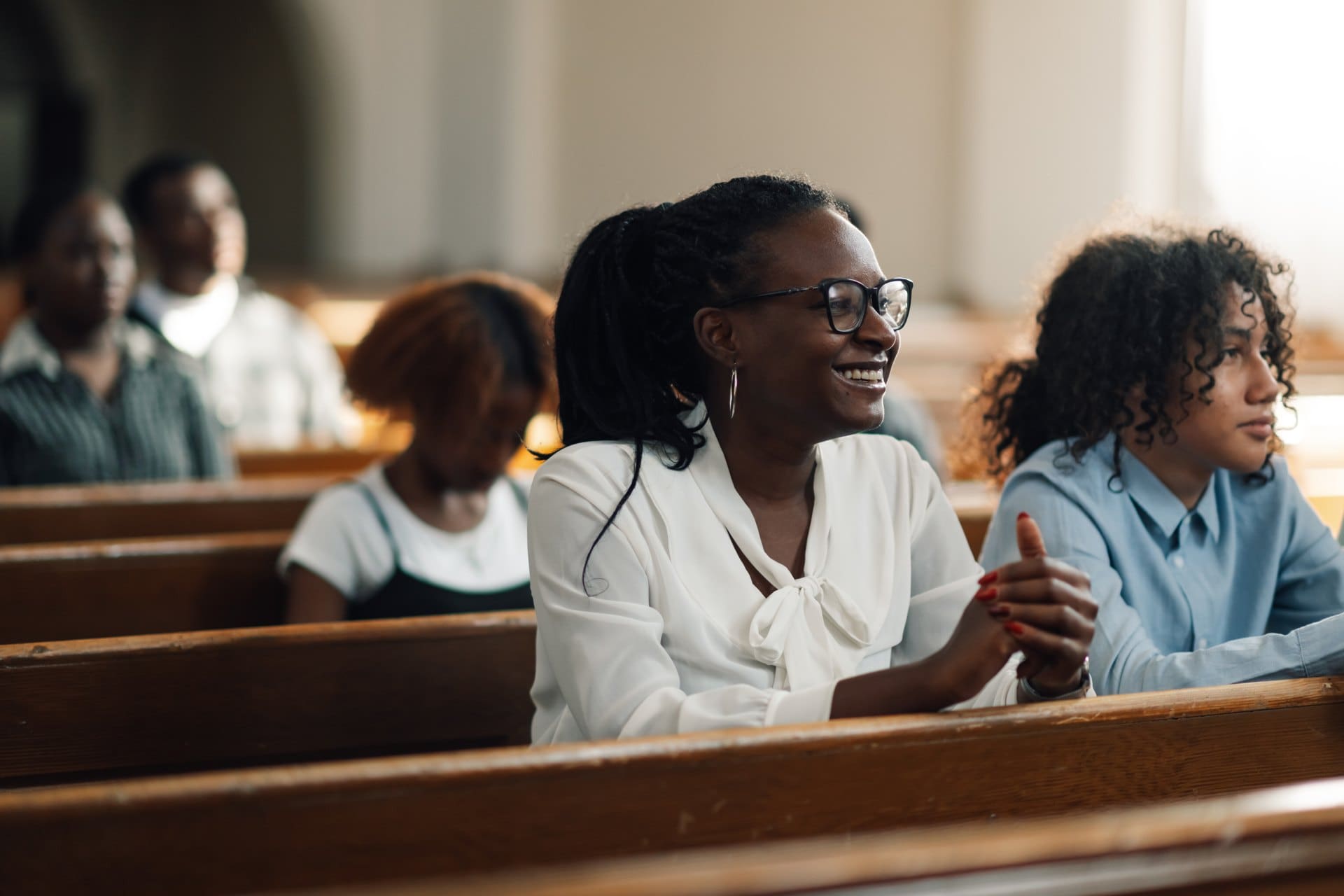 Women gathered in church pews during a service.